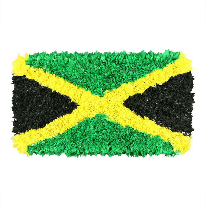 An electric, three-dimensional interpretation of the Jamaican flag stands here, built from densely packed, small crinkled pieces of material-recycled paper, fabric scraps, or even upcycled plastics-each fragment catching the light and contributing to a rich, tactile surface. The hallmark is a bold gold saltire that runs diagonally from corner to corner, dividing the canvas into four vibrant triangles. The upper and lower fields glow emerald green, while the left and right fields carry a deep, matte black. Every color block is formed from countless tiny elements, producing an energetic, uneven texture that speaks of handcraft and care. The object rests on a plain white background, heightening the contrast and making the surface details stand out-folds, creases, and the subtle shining edges of each piece. This interpretation of Jamaica's emblem carries a message of national pride, cultural identity, and sustainable creativity, inviting viewers to consider how art can transform everyday materials into meaningful symbols. For readers in Greenhithe exploring community art, sustainability, or local celebration, this image resonates as a reminder that craft can turn shared symbols into accessible, tangible memories. It's the kind of artwork that could accompany coverage of a street festival, a cultural fair, or a heritage project along the river paths near Bluewater and Ebbsfleet.