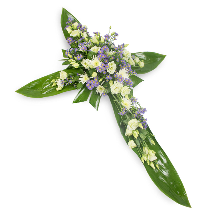 This heartfelt floral cross combines bold botanical structure with delicate blossoms to form a composed tribute suitable for moments of mourning and reflection. Laid out on a plain white background and photographed from a subtle overhead viewpoint, the cross's shape is confidently defined by sweeping, glossy green tropical leaves, their broad blades overlapping to create a smooth, verdant base with visible midribs and a faint sheen. Concentrated at the intersection and extending along each arm, clusters of soft, creamy white lisianthus present ruffled, layered petals and occasional closed buds that suggest both beauty and quiet restraint. Among them, small white chrysanthemums or miniature spray roses add roundness and gentle brightness, while abundant tiny lavender-hued blooms-likely limonium or small asters-offer a soft counterpoint of color and airiness. Thin, feathery greens are tucked through the florals to enhance depth and provide natural punctuation without distracting from the cross's symbolism. The light is soft and even, revealing the contrast between the waxy leaf surfaces and the petal textures, and the scent is subdued-green and faintly sweet, an unobtrusive companion to the arrangement's visual calm. As a florist in the Greenhithe area I choose compositions like this for funeral chapels, memorial services, or as a graveside expression of faith and remembrance, mindful of local customs and the need for a dignified, comforting presence.