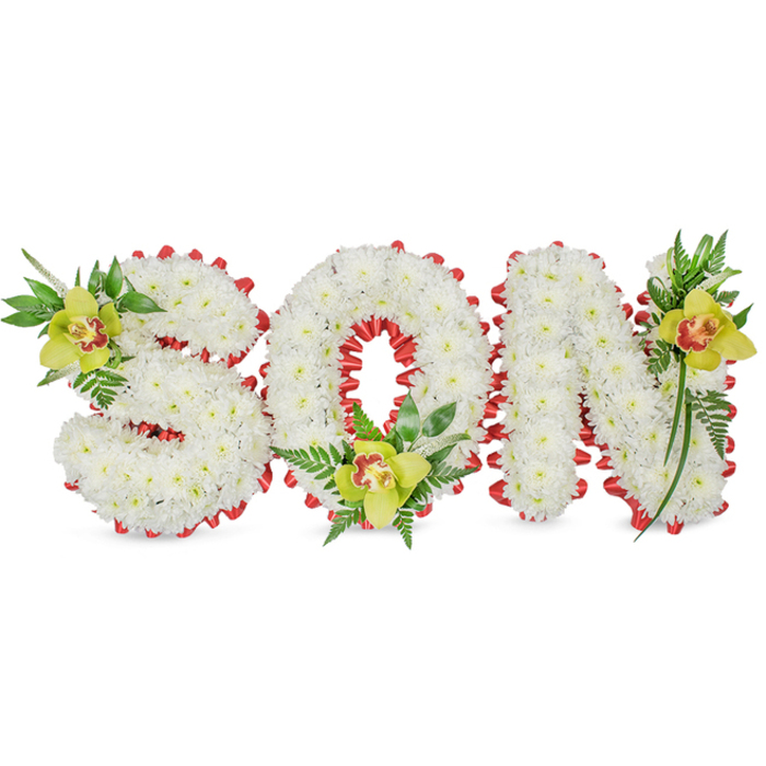 A meticulously made memorial arrangement spells SON in three-dimensional, block-style letters, each letter tightly packed with small, pristine white chrysanthemums to form a continuous, cushion-like surface that reads as calm and reverent. The composition is set against a plain white background so the textures and shapes are highlighted without distraction; a continuously folded red ribbon is worked around the perimeters and into the O to form a delicate scalloped edge, introducing a vivid and respectful contrast to the white. Positioned to balance the three letters are three lime-green Cymbidium orchids, each exhibiting waxy, long-lasting petals and a distinct reddish-brown marking in the throat; one orchid nestles in the S, another cradles the lower O and a third accents the upper stroke of the N. Surrounding the orchids and integrated between the letters is a carefully chosen selection of foliage-slender upright leaves, glossy broad greens and fine fern fronds-that adds vertical movement, fills negative space and lends a sense of natural renewal. The lighting is soft and neutral to emphasise texture rather than cast dramatic shadows, allowing viewers to appreciate the craftsmanship and the symbolic colour interplay. This arrangement is meant for funeral chapels, memorial services or graveside placement, offering a clear, personalised message of love and remembrance for a son. Local families from Greenhithe, those visiting Bluewater or attending services around Shorne Woods and the Thames riverside often request this restrained, heartfelt style for its clarity and comforting presentation.